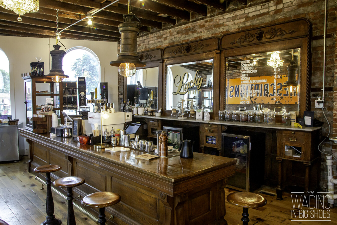 Lucky Detroit Coffee Roasters interior with a wooden espresso bar and exposed brick